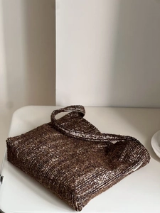 Detailed macro shot of the textured brown woven fabric on this minimalist tote bag