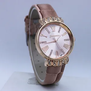 Detail of rose gold ladies' watch featuring diamond-set lugs and a pink Roman numeral dial