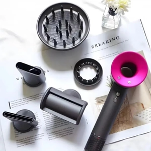 High-speed bladeless hair dryer in matte grey with five magnetic styling attachments