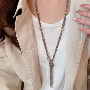 Multilayer chain necklace with golden beads and knotted tassel design for women
