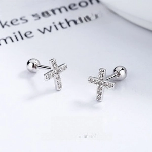 Macro shot of 925 sterling silver cross studs with cubic zirconia and screw-back closure
