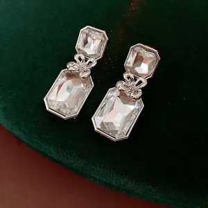 Silver square floral earrings set with crystal stones and delicate metal bow details