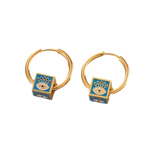 Golden hoop earrings with sky blue cubic evil eye pendants in an elegant luxury style