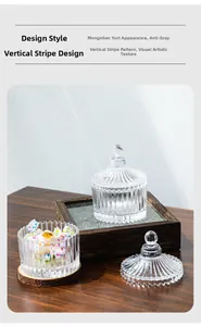 Detailed close-up of ribbed glass storage jar with candies on a dark wood tray