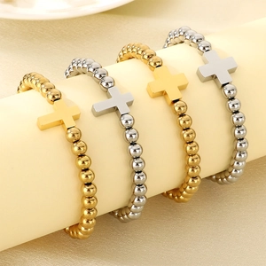 Detailed shot of 6mm gold and silver beaded cross bracelets on a display stand