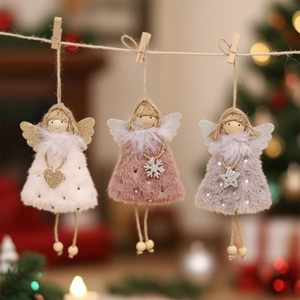 Three plush angel Christmas tree ornaments in cream, pink and grey hanging on a jute rope