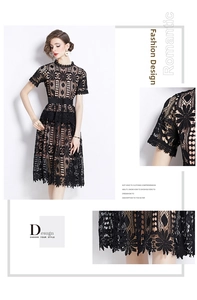 Detail view of black hollow out lace dress with intricate embroidery and petal hem