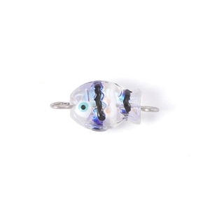Close-up of a handmade glass fish bead with blue eyes and stripes for jewelry making