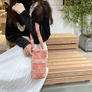 Detailed texture of pink and beige checkered plush tote bag in soft lamb wool fabric