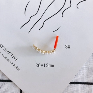 Detail of heart cross pearl earring pendant with red protective sleeve on 26x12mm post