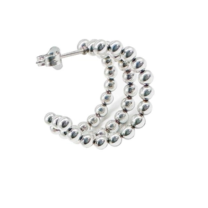 Detailed view of silver triple-row beaded C-shaped earrings with high polish finish