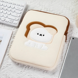Detailed close-up of thick beige tablet sleeve with bread bear embroidery and brown zipper
