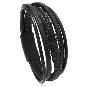 Close-up of black braided leather multilayer bracelet with magnetic clasp and tree of life charm