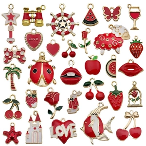 Assorted red enamel gold-plated charms featuring hearts strawberries and animal shapes