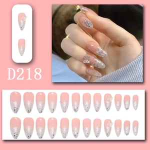 Detailed view of long almond press-on nails with silver glitter and 3D butterfly charms
