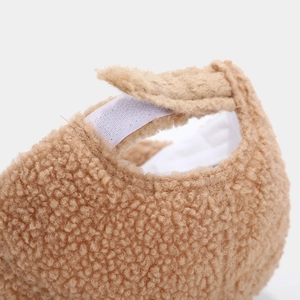 Detailed macro view of camel faux shearling fabric texture with white velcro fastener