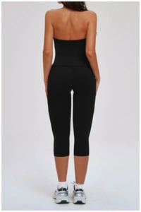 Rear view of black high-waisted yoga leggings and open-back sports top for fitness