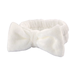 Soft white plush headband with large bow for face washing and makeup application