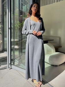 Detail of grey knitted two-piece set featuring long cardigan and v-neck maxi dress