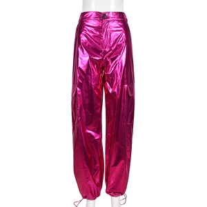 Detail of glossy metallic rose pink cargo pants featuring high-waisted cut and Y2K style