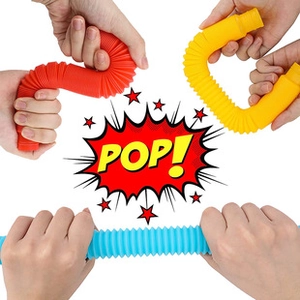 Macro view of colorful stretchable pop tubes in red blue and yellow being pulled and bent
