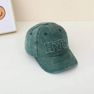 Détail de la casquette en coton vert délavé avec broderie de lettres HYC