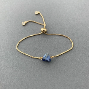 Detail of adjustable 14K gold-plated box chain bracelet with blue natural stone and zircon