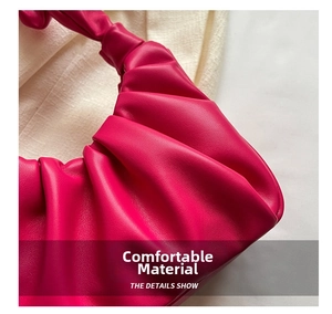 Detail view of hot pink pleated leather texture on a chic French style underarm bag