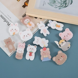 Cute cartoon animal acrylic pins featuring colorful bears and bunnies on a blue background