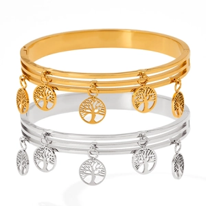 Close-up of gold and silver stainless steel bangles featuring hollow Tree of Life charms
