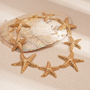 Detailed view of textured gold starfish pendant necklace with adjustable lobster clasp