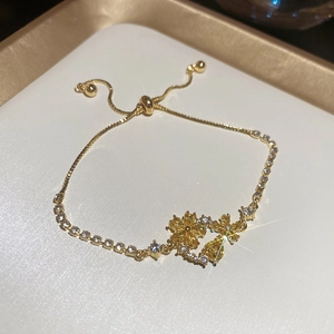 Detailed macro of 18k gold plated flower bracelet with shimmering zircon stones