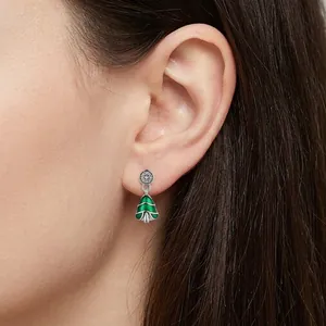 S925 sterling silver Christmas tree earrings with green enamel on a model