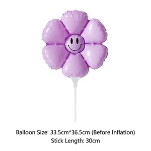 Purple daisy foil balloon with smiley face detail, measuring 33.5x36.5cm with 30cm handle