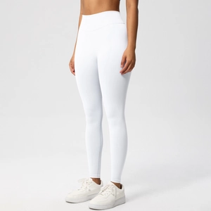 Detail view of the high-waisted wide waistband on seamless white yoga leggings