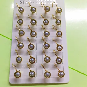 Polished stainless steel gold earrings set with lavender pearls on display card