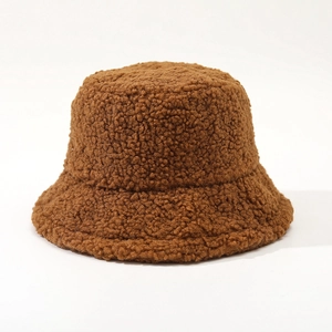 Close-up of the fluffy texture and thick brown lamb wool fabric of the winter bucket hat