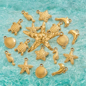 Gold stainless steel ocean pendants featuring starfish, turtles, and shells on water background