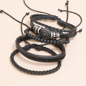Set of four vintage black braided leather bracelets with wooden beads and metal accents