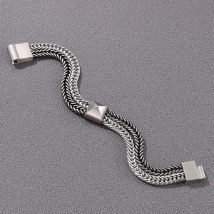 Macro detail of double-layered stainless steel dragon bone chain with pyramid metal stud