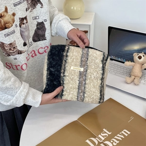 Grote cosmetische tas van sherpa boucle met blauwe en crème strepen en ritssluiting