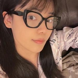 Detailed close-up of glossy black cat-eye eyeglass frames for women with a premium finish