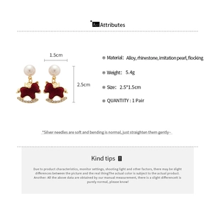 Detail showing dimensions and materials of wine red flocked rocking horse earrings