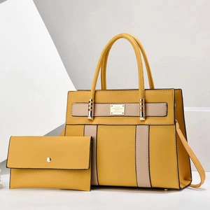 Detail of yellow minimalist tote bag and matching envelope wallet set with gold hardware