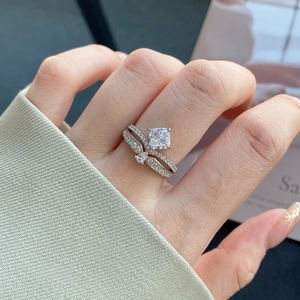 Close-up of a square-cut sparkling zircon ring with a double-layer crossover silver band