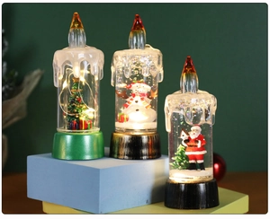 Three LED Christmas snow globe lanterns with Santa, snowman and tree on geometric stands