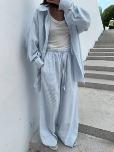 Detail of light blue striped shirt set with elastic drawstring waist on wide-leg trousers