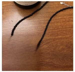 Detailed close-up of S925 sterling silver bow pendant and necklace clasp with S925 hallmark