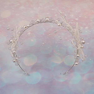 Elegant bridal floral headband with white pearls and iridescent beads on silver wire