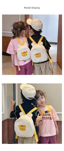 Detail showing the adjustable yellow straps and safety chest buckle on a kids canvas backpack